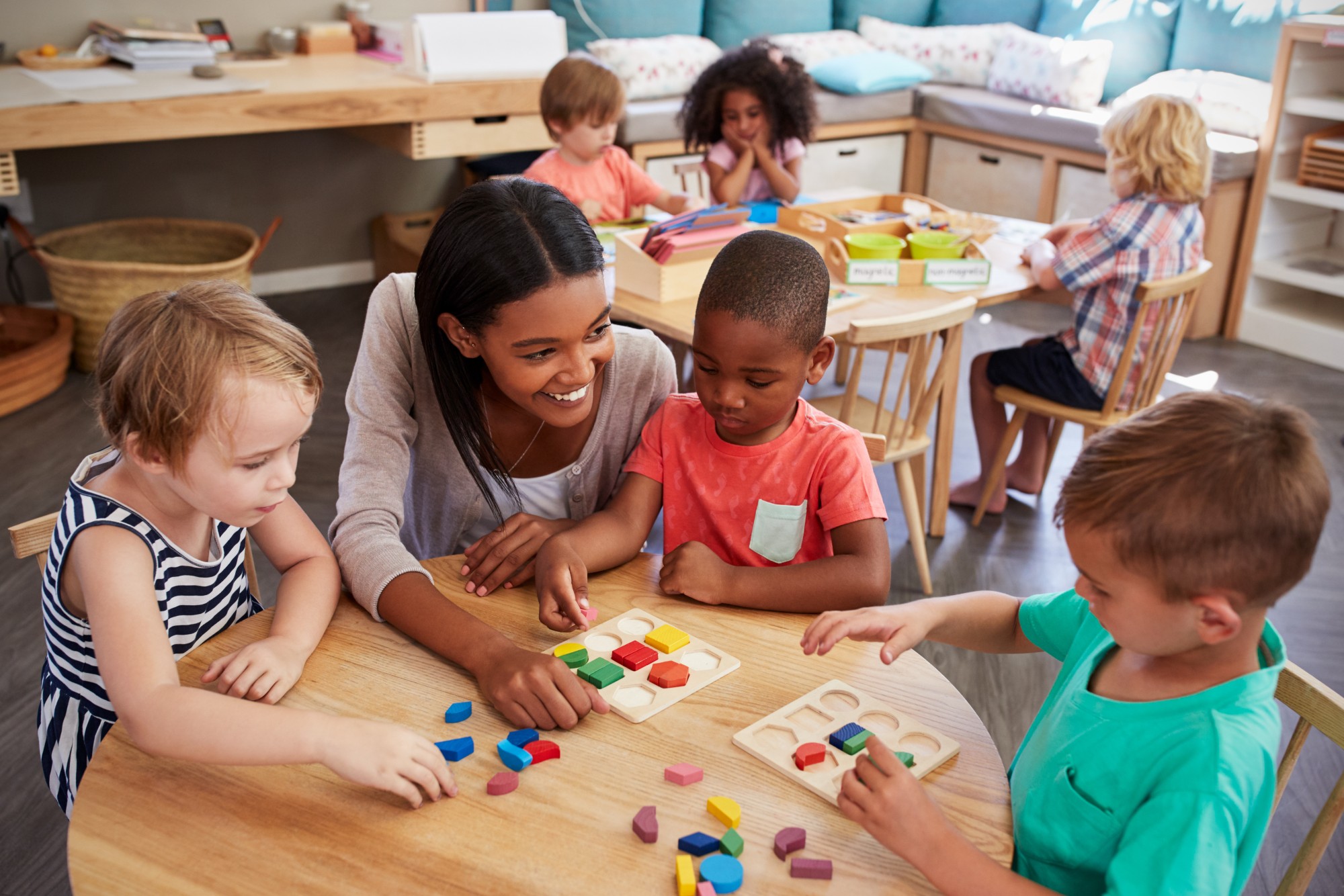 school teacher helping kids in class room