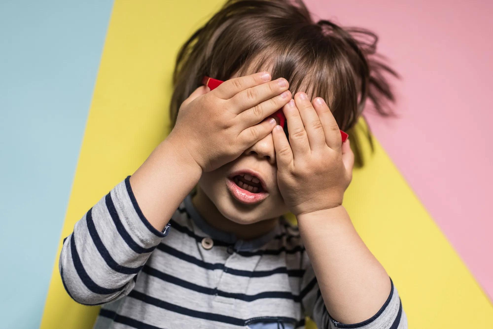 child playing peekaboo